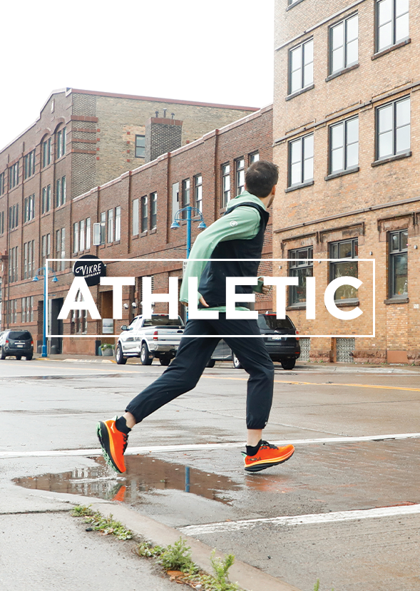 man running across street in athletic shoes